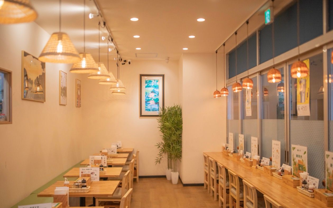 Inside the Viet Origin Hongo store — warm seating under rattan lamps